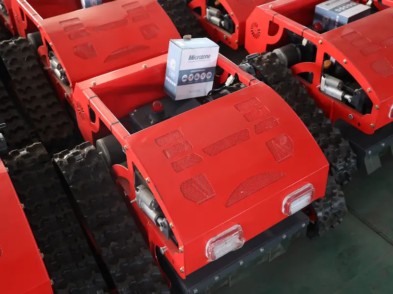 several-red-mowers-neatly-arranged-in-a-factory-warehouse